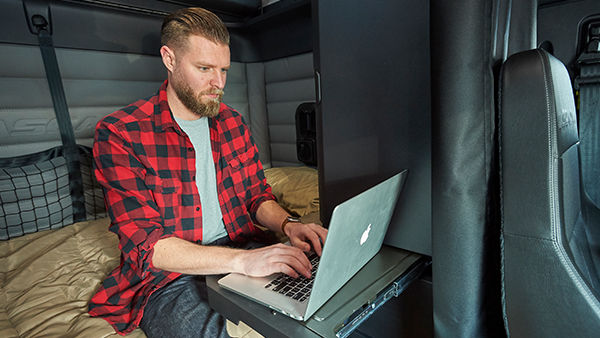 Man on laptop in truck