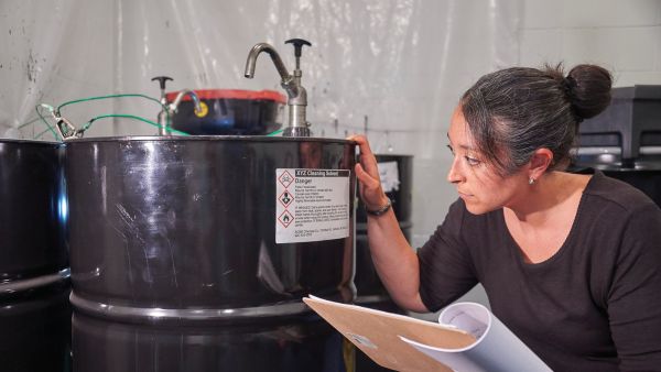 Employee Reading Chemical Label